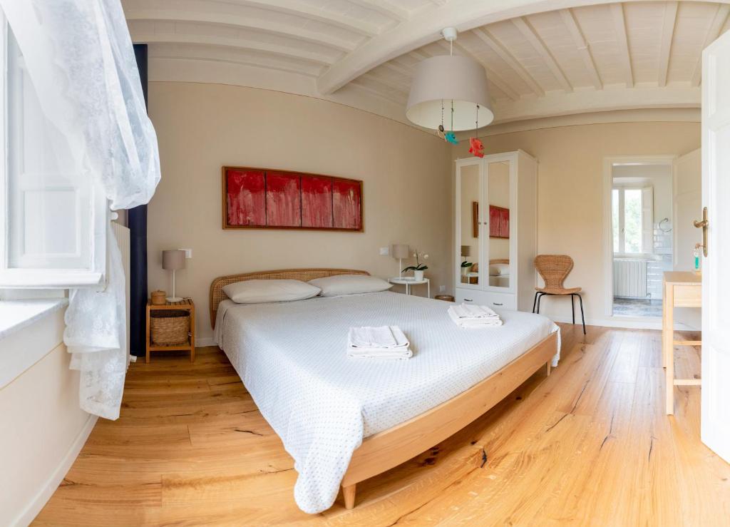 a bedroom with a large white bed in a room at La Dimora di Corte in Lucca