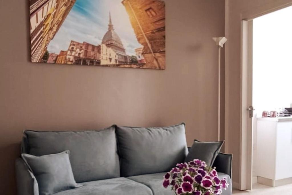 a living room with a couch and a picture on the wall at Casa Stadio - Parco Dora in Turin