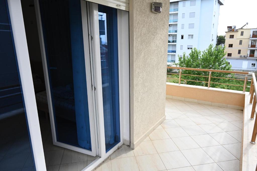 a balcony with sliding glass doors on a building at Iris apartaments in Sakës
