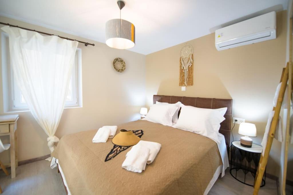 a bedroom with a large bed with towels on it at Casa Iolanda I in Corfu