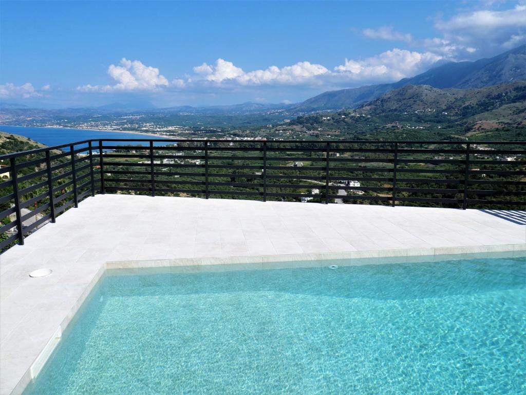 a swimming pool with a view of the mountains at Villa ArGia with private pool in Georgioupoli