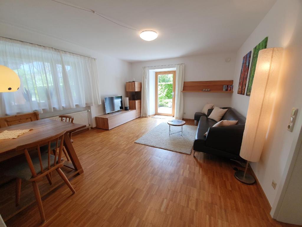 a living room with a table and a couch at Ferienwohnung BaMBi in Prien am Chiemsee
