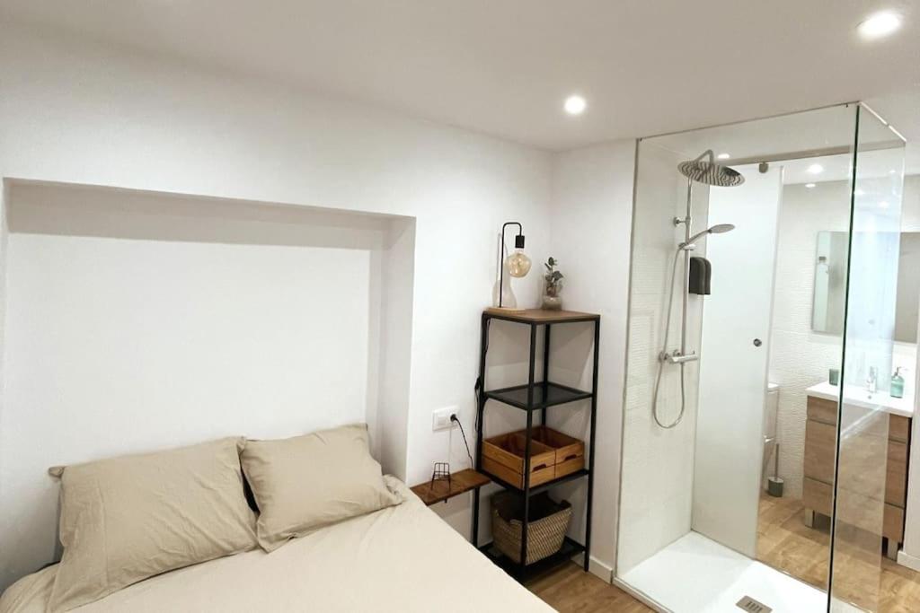 a bedroom with a bed and a glass shower at Unique apartment in Coruña Old Town in A Coruña