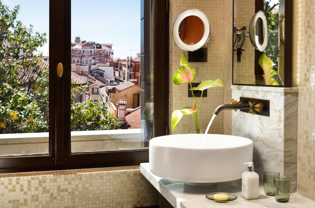 a bathroom with a sink and a window at Palazzo Venart Luxury Hotel in Venice