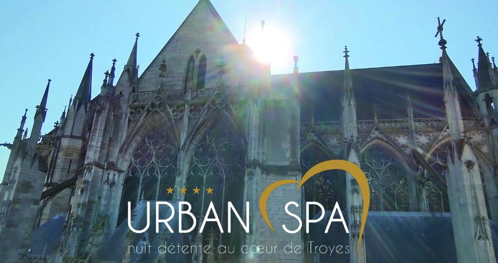a large cathedral with the sun setting behind it at Urban Spa Cosy Zen in Troyes