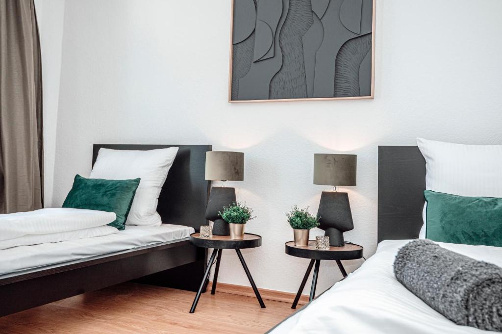 a bedroom with two beds and two lamps on tables at Dream for 4 - Smart TV in Krefeld