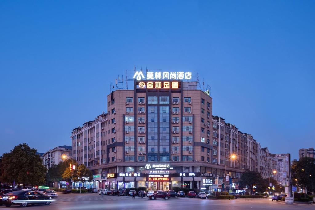 a tall building with a sign on the top of it at Morninginn,Liangang in Loudi