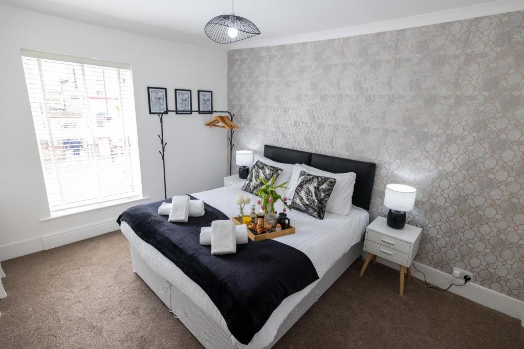 a bedroom with a bed with a tray of food on it at Cosy Home by the Sea in Great Yarmouth in Southtown