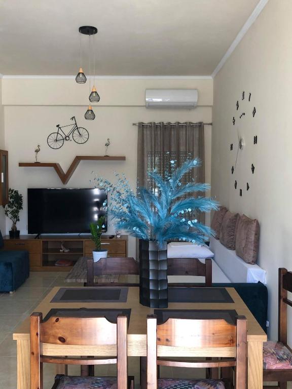 a living room with a table and a tv at Frosos house in Kefalos