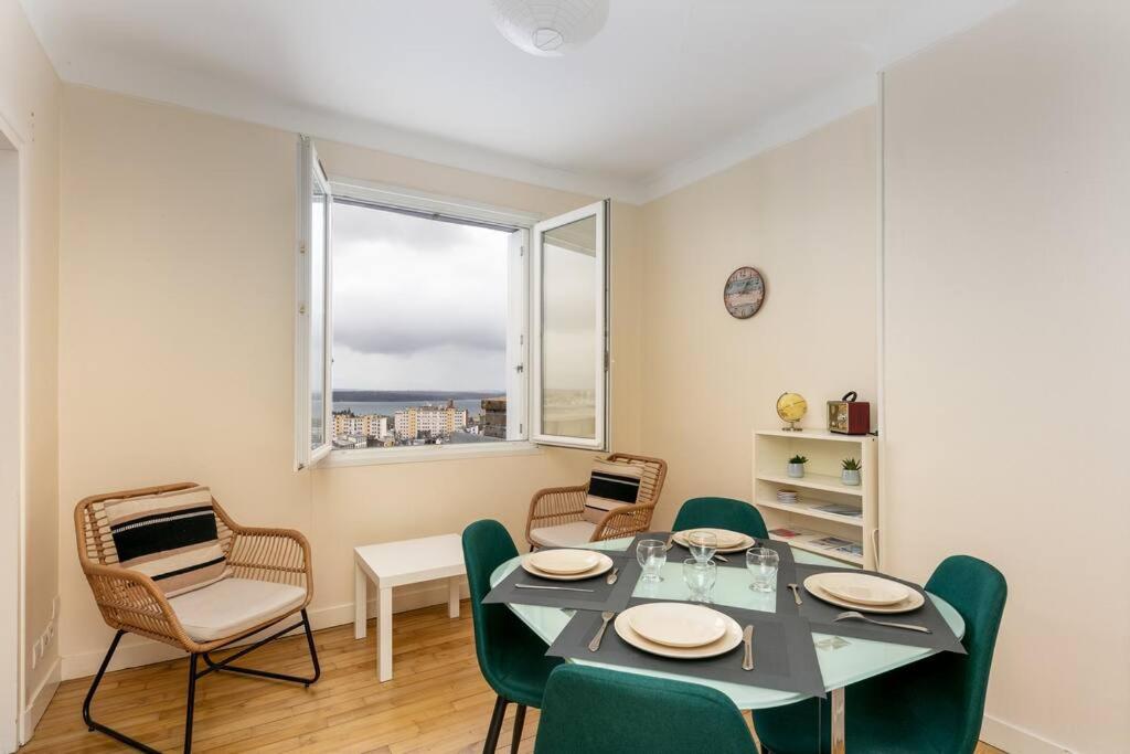 a dining room with a table and chairs and a window at Vue mer &#47; Jaurès-Centre-Ville &#47; Appart Lumineux in Brest