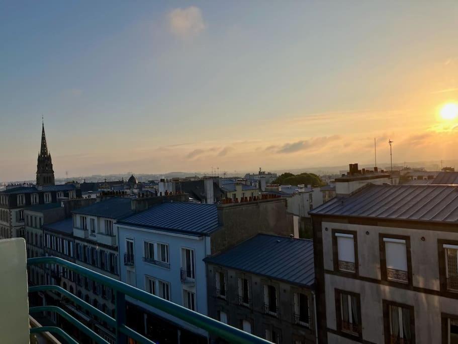 a view of a city at sunset from a balcony at Vue mer &#47; Jaurès-Centre-Ville &#47; Appart Lumineux in Brest