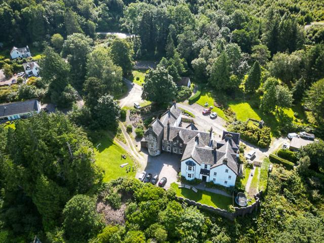 an aerial view of a large house in the forest at Ardbrecknish House in Dalmally