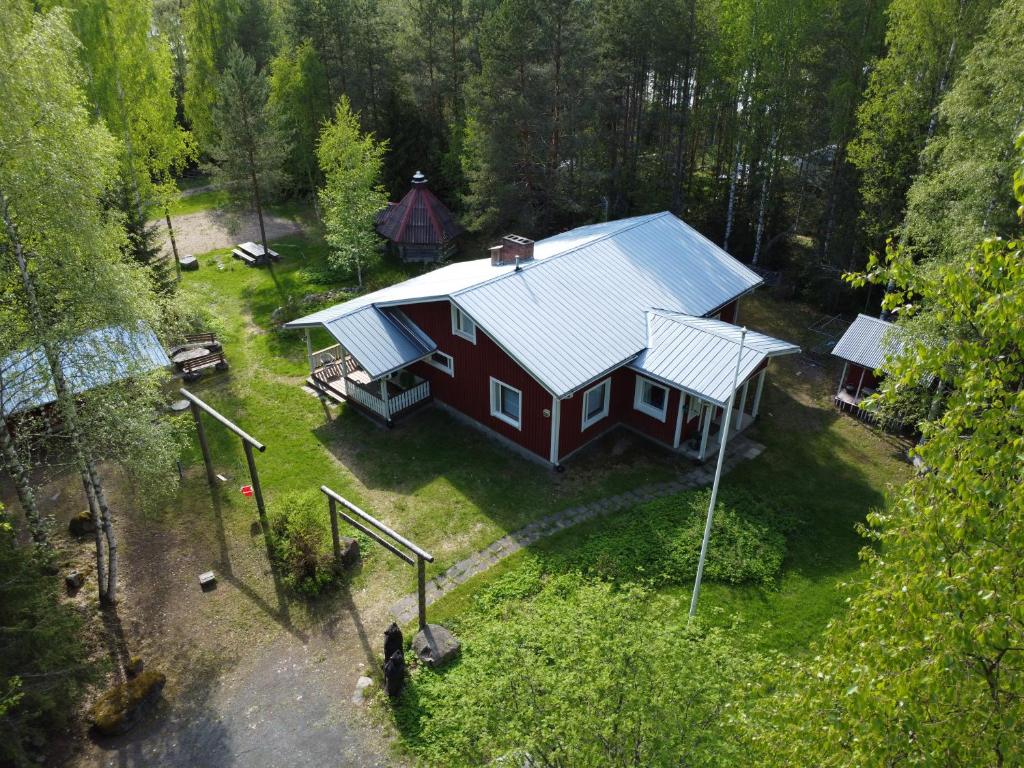 an aerial view of a red house with a blue roof at Lomakoti Tuulensuoja in Kärväsjärvi