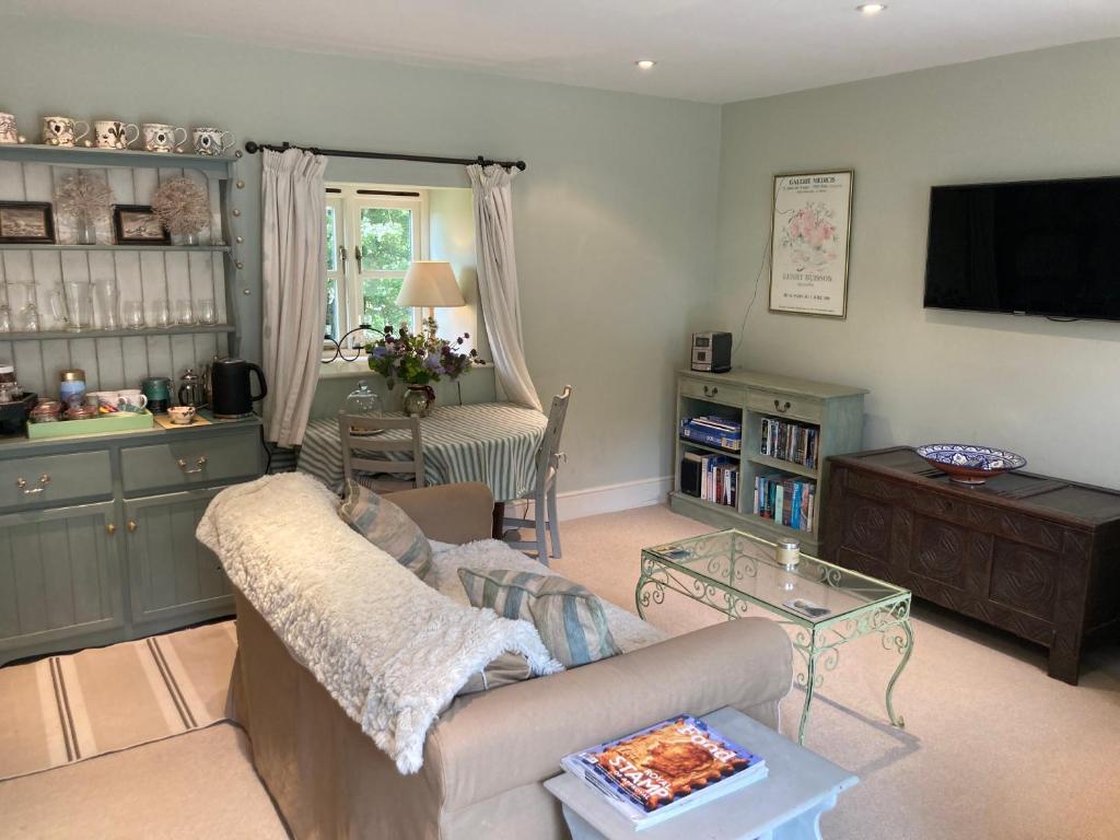 a living room with a couch and a table at Eydon B&B in Daventry