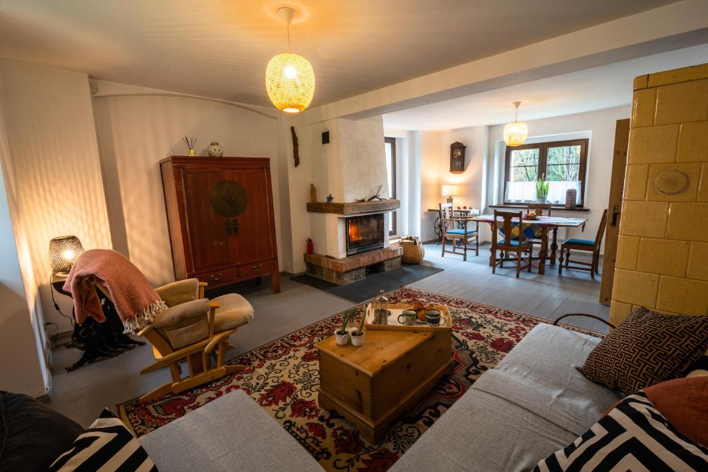 a living room with a couch and a coffee table at Stara Szlifiernia - dom na wyłączność in Szklarska Poręba