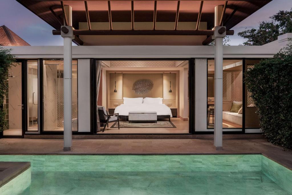 a bedroom with a bed and a pool at Banyan Tree Phuket in Bang Tao Beach