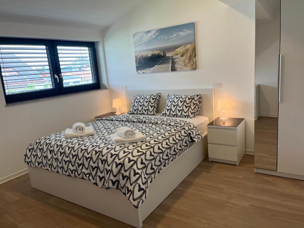 a bedroom with a bed with a black and white comforter at Villa Kovačeva 15, app 2, free parking in Ljubljana