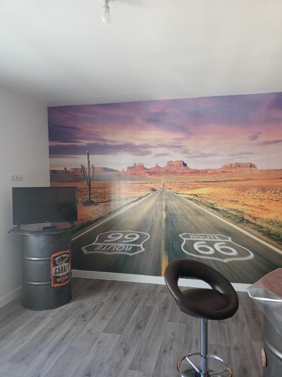 a wall mural of a road in the desert at Appart 3 chambres in Noyen-sur-Sarthe