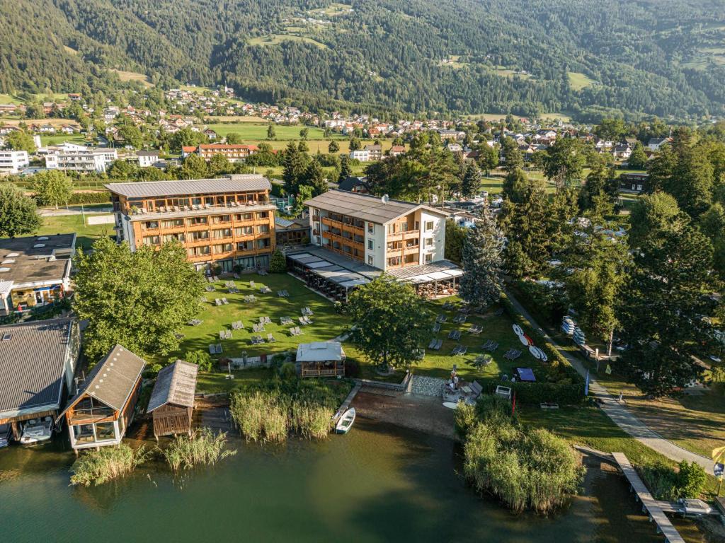 an aerial view of a building next to a river at Hotel SeeRose in Bodensdorf