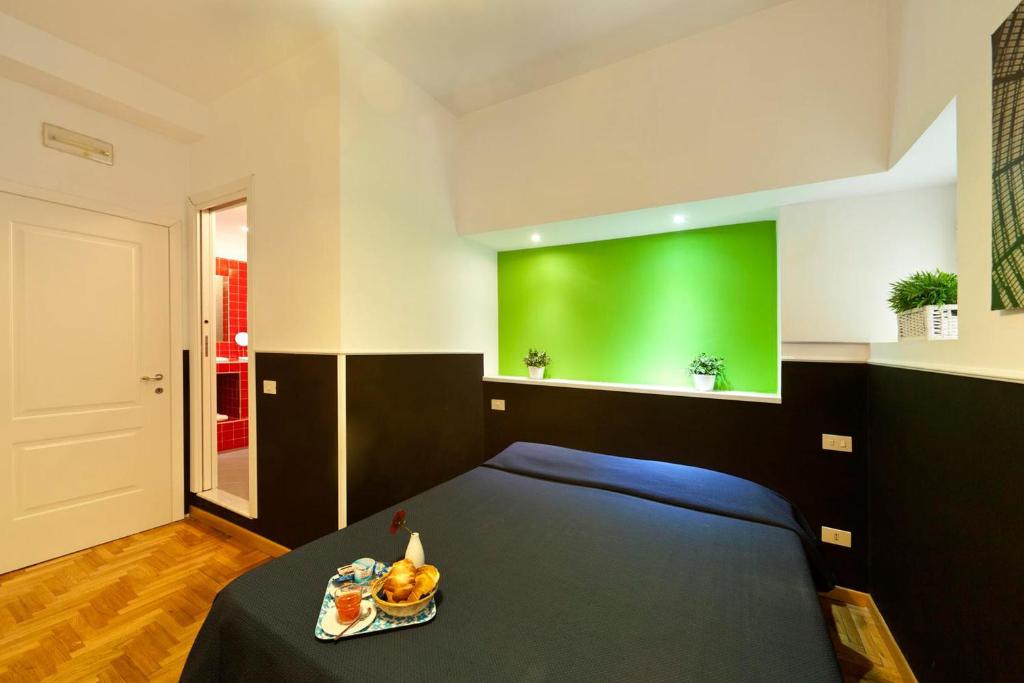 a bedroom with a bed with a green wall at B&B Cappella Vecchia 11 in Naples