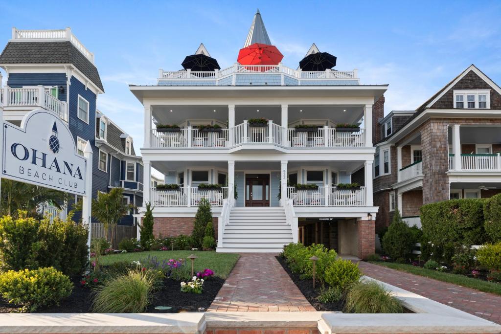 a white house with a red roof at Cape May Ohana Beach Club in Cape May