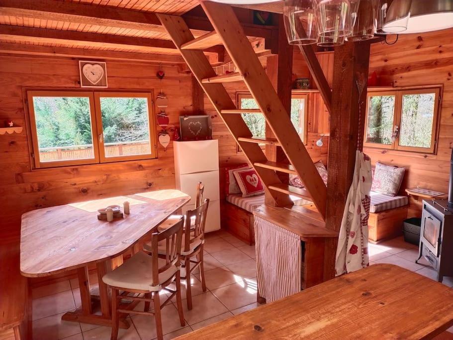 a kitchen with a table and a dining room at Chalet 1 chambre in Chenecey-Buillon