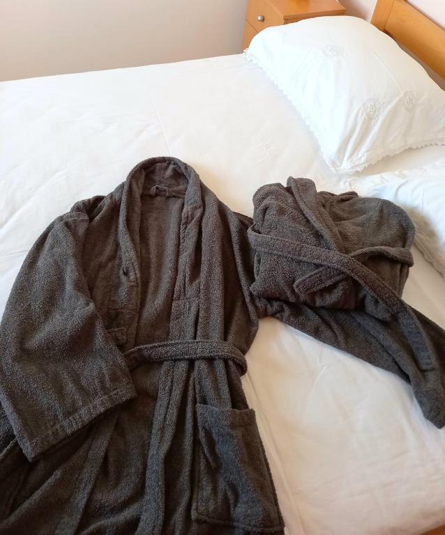 a robe laying on top of a bed at Kat&#39;s - Roman Salona in Solin