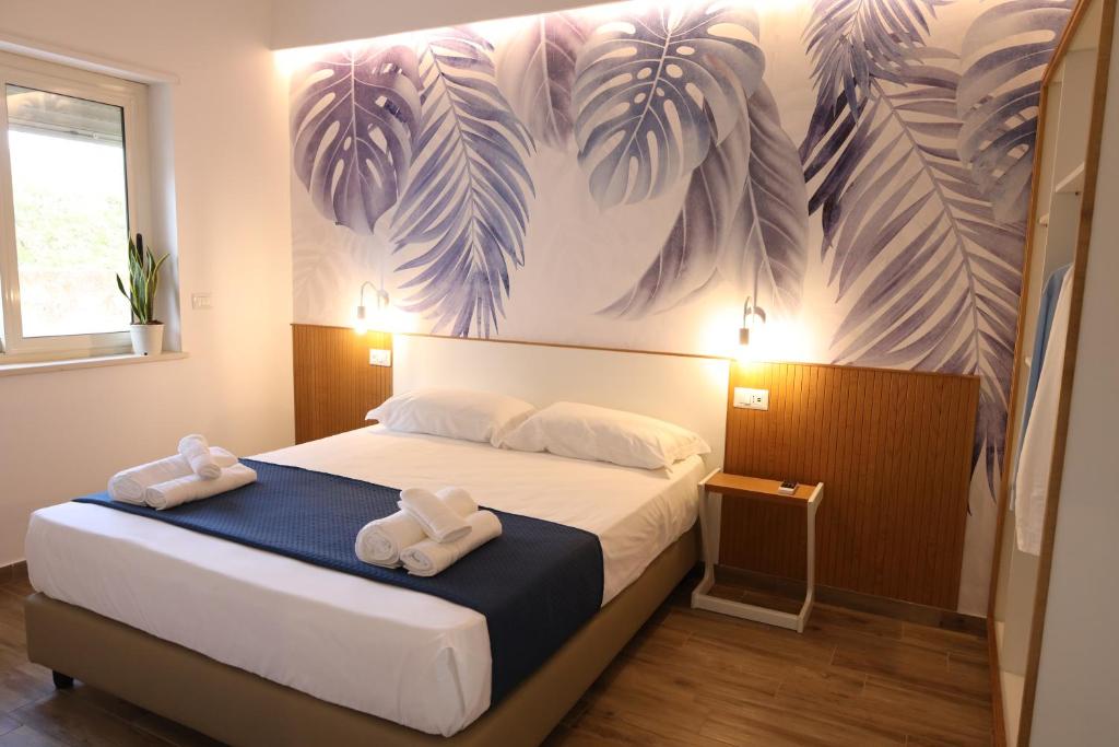 ein Schlafzimmer mit einem Bett mit zwei Handtüchern darauf in der Unterkunft SUNSEA - Enjoy Your Family in Capo Vaticano