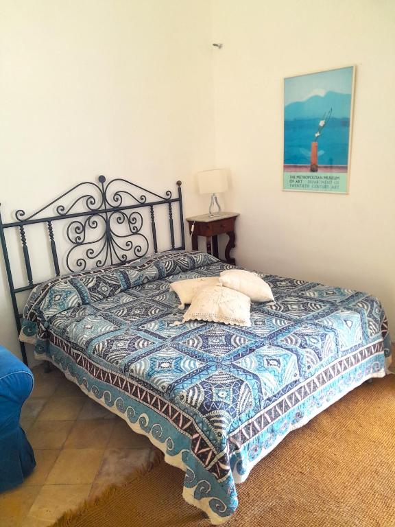 a bed with two pillows on it in a room at Casa Marina in Forio d'Ischia