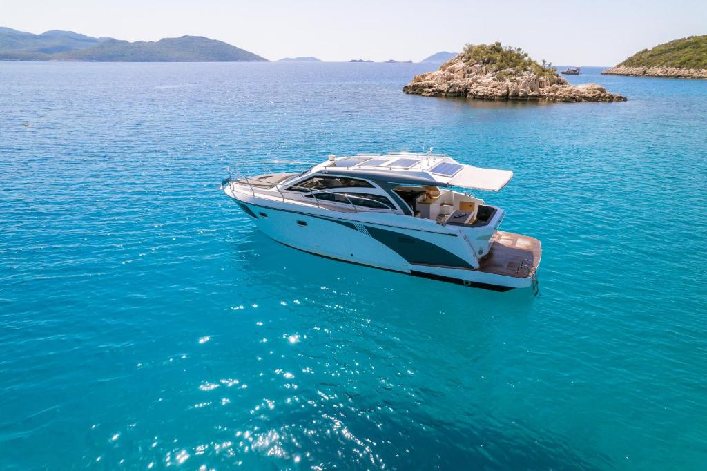 a boat floating in the water on a large body of water at Blue Neptune Yacht in Kaş
