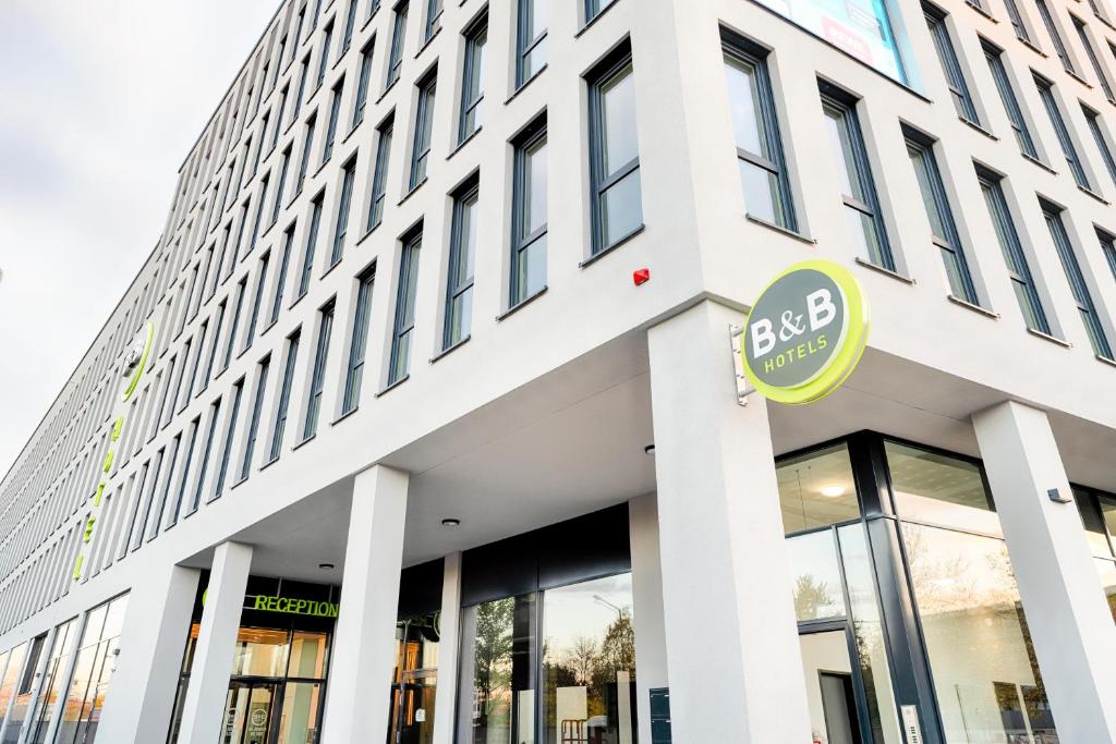 an office building with a sign on the front of it at B&B Hotel Nürnberg-West in Nürnberg