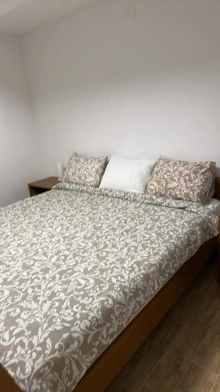 a bed with two pillows on top of it at Apartments Linic in Nin