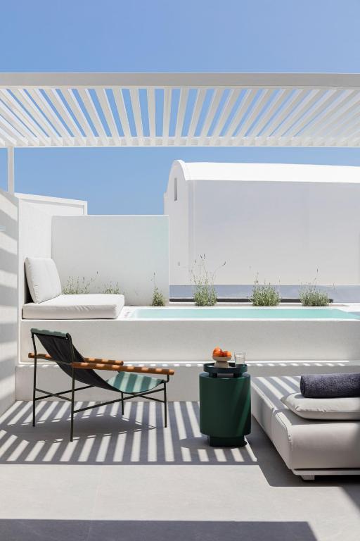 a living room with a couch and a table at Neo Suites in Fira
