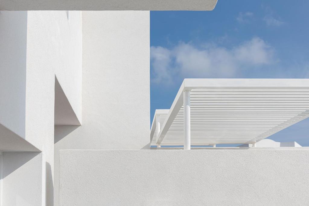a view of a white building with a roof at Neo Suites in Fira