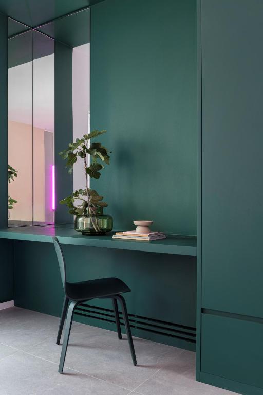 a desk with a chair and a plant on it at Neo Suites in Fira