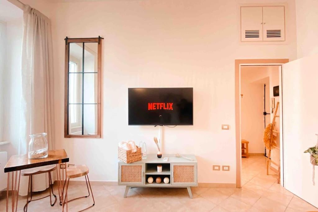 a living room with a tv on a white wall at Locazione turistica Davide in Anzio