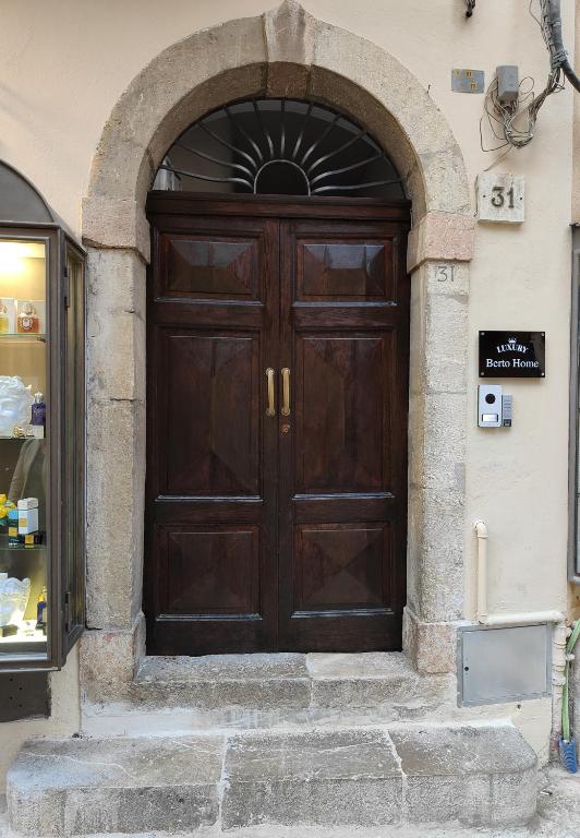 a large wooden door in a building at Luxury Berto Home in Taormina