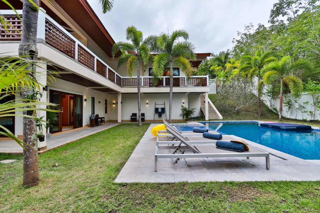 an exterior view of a house with a swimming pool at Cliff Haven Villa Krabi in Ao Nang Beach