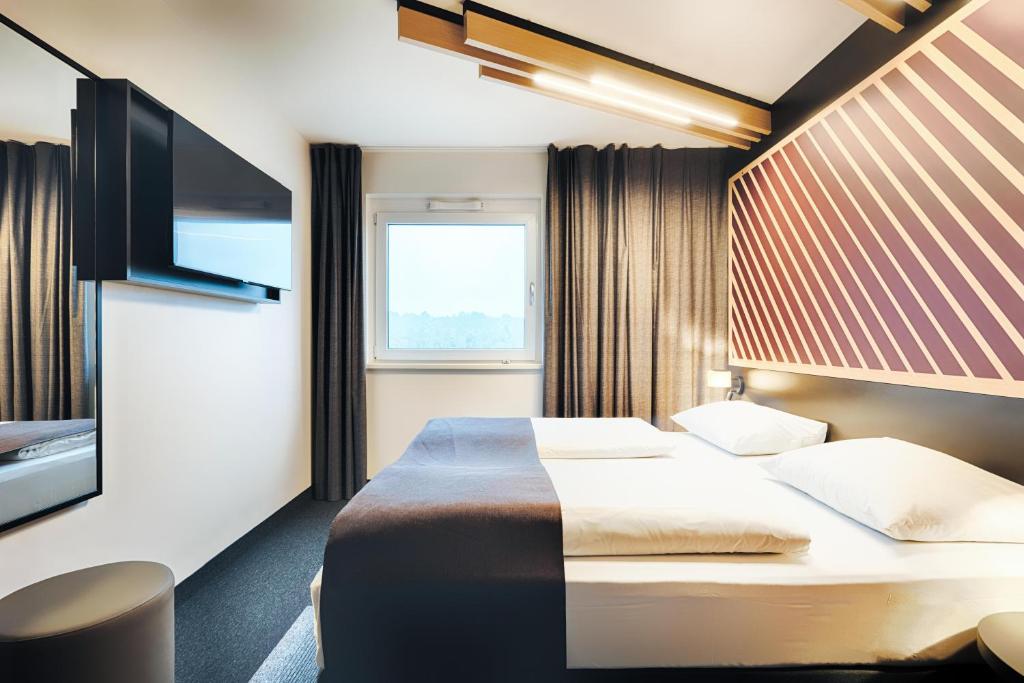 Postel nebo postele na pokoji v ubytování B&B HOTEL Wiesbaden-Hbf