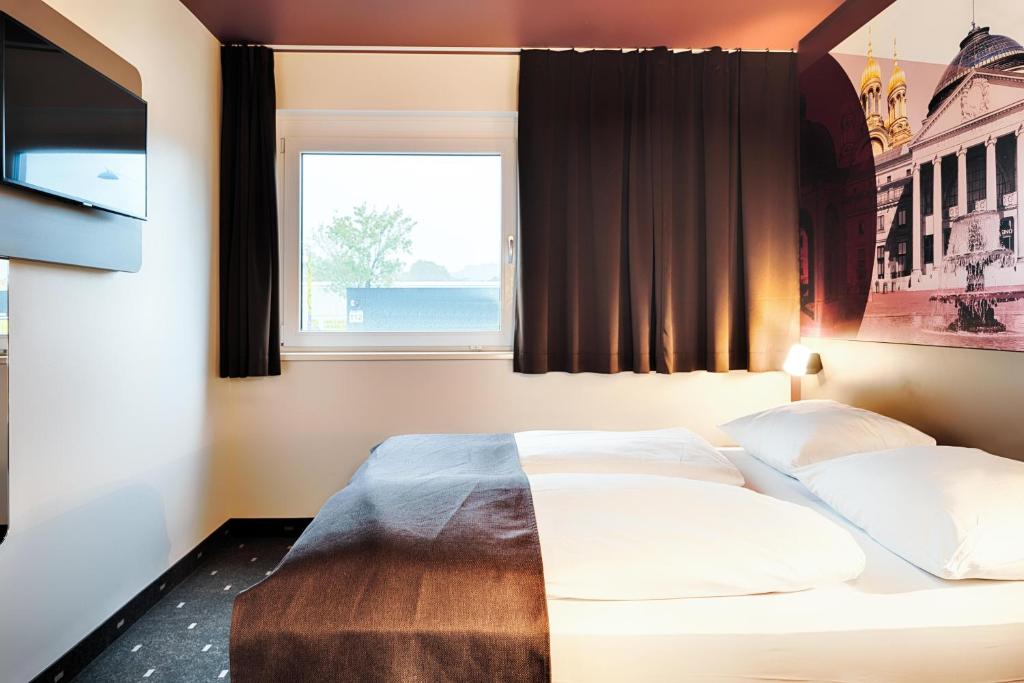 Postel nebo postele na pokoji v ubytování B&B HOTEL Wiesbaden-Hbf