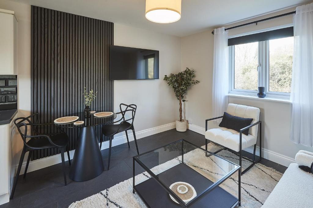 a living room with a table and chairs at Vert Vale Apartment in Newcastle upon Tyne