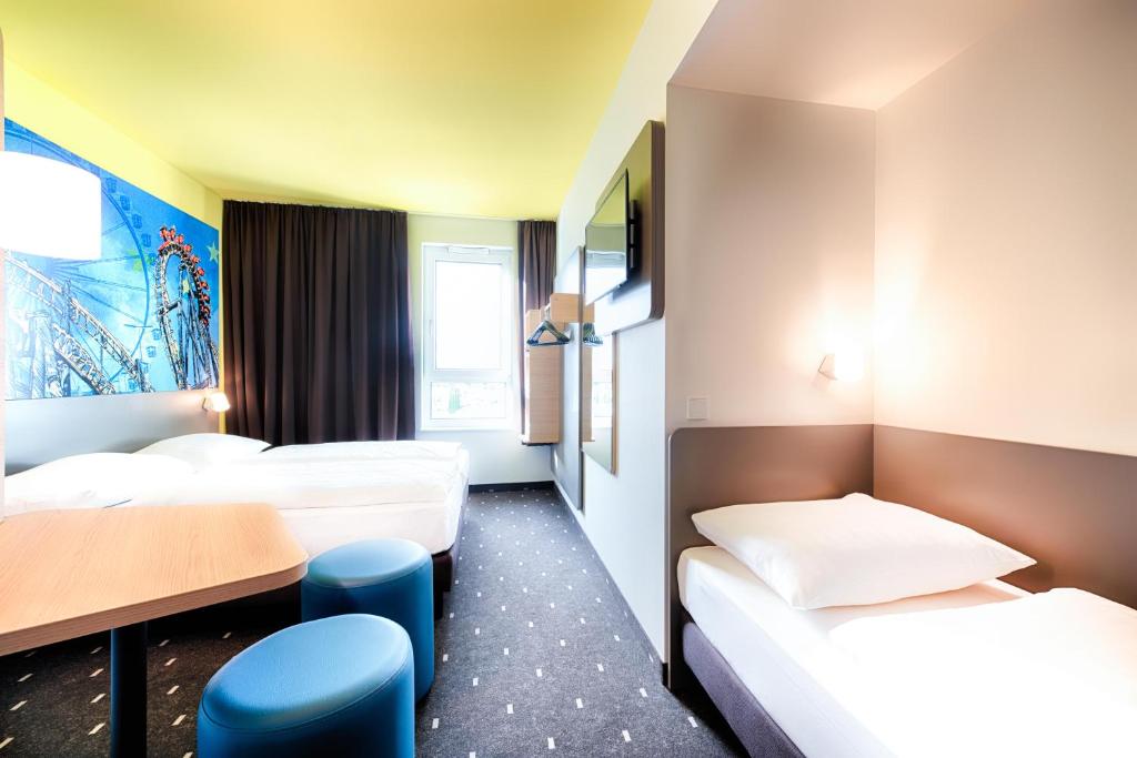 Postel nebo postele na pokoji v ubytování B&B Hotel Rust-Ettenheim