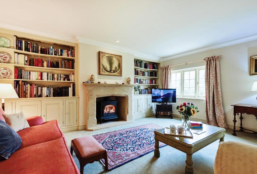 a living room with a couch and a fireplace at The Old Rectory Lodge in Dorchester