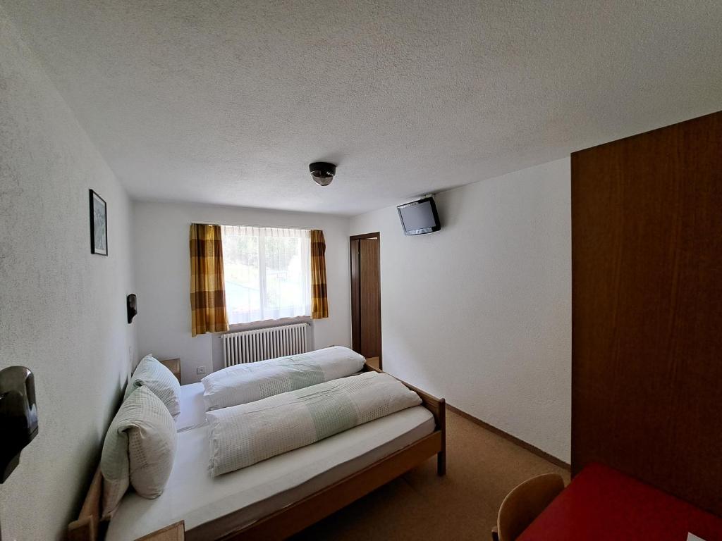 Postel nebo postele na pokoji v ubytování Hotel Posta