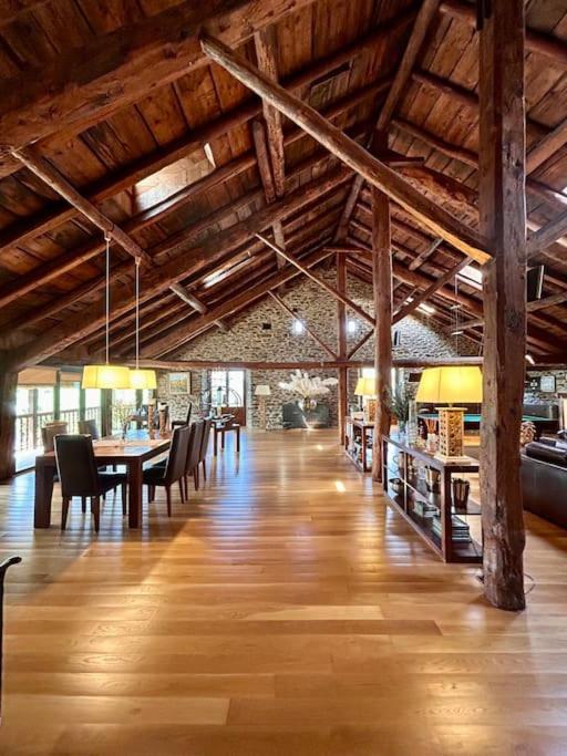 a large room with wooden ceilings and tables and chairs at Cobert de Felip 