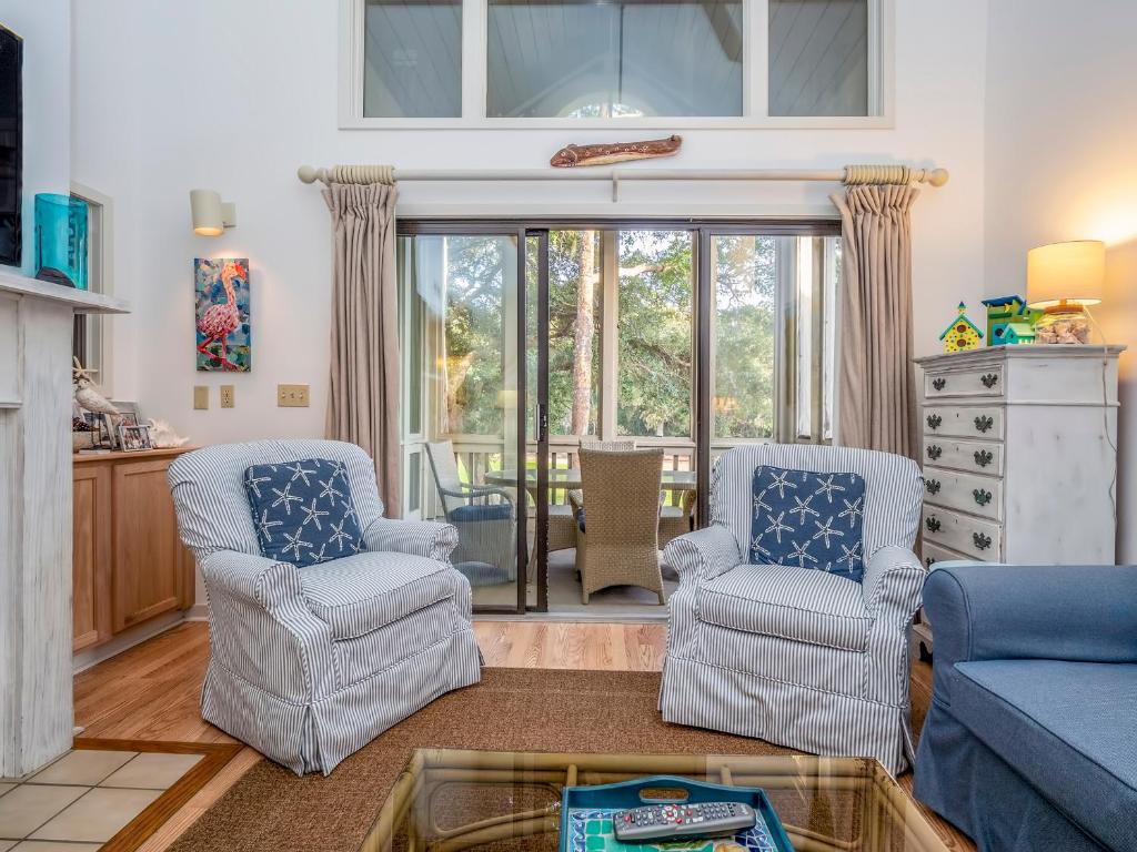 a living room with two chairs and a table at 2780 Live Oak Villa in Seabrook Island