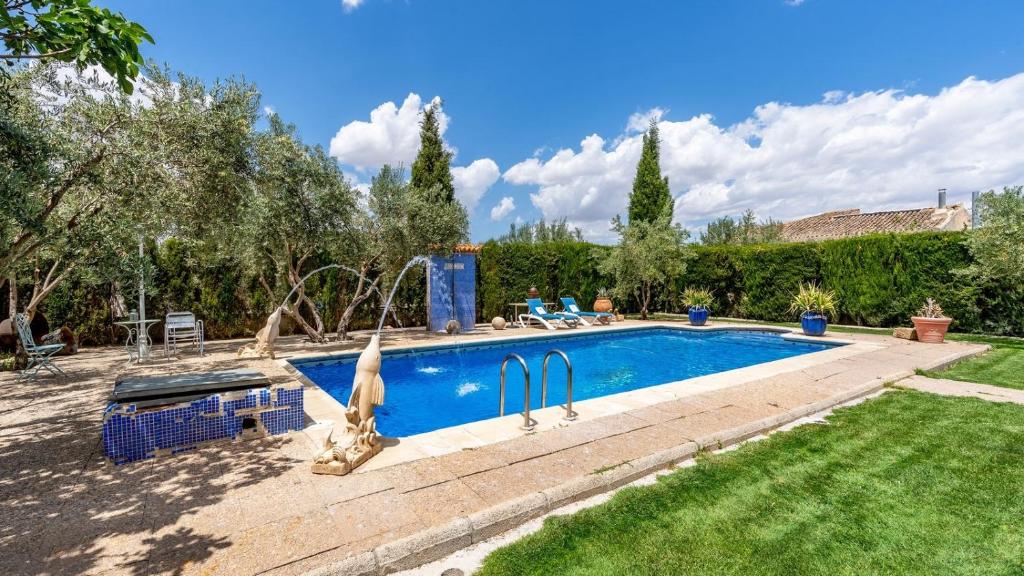 a swimming pool in a yard next to at Cortijo Bustamante Baza by Ruralidays in Baza