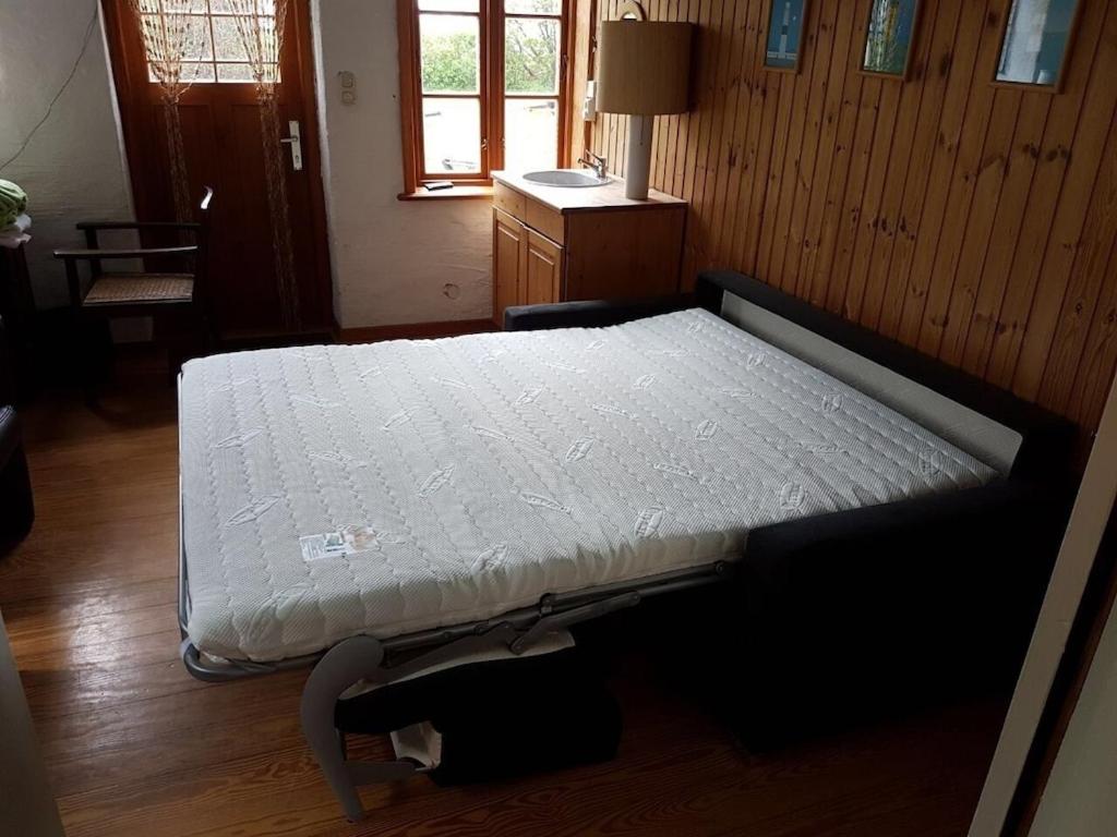 Postel nebo postele na pokoji v ubytování Alte Stellmacherei Langenhorn