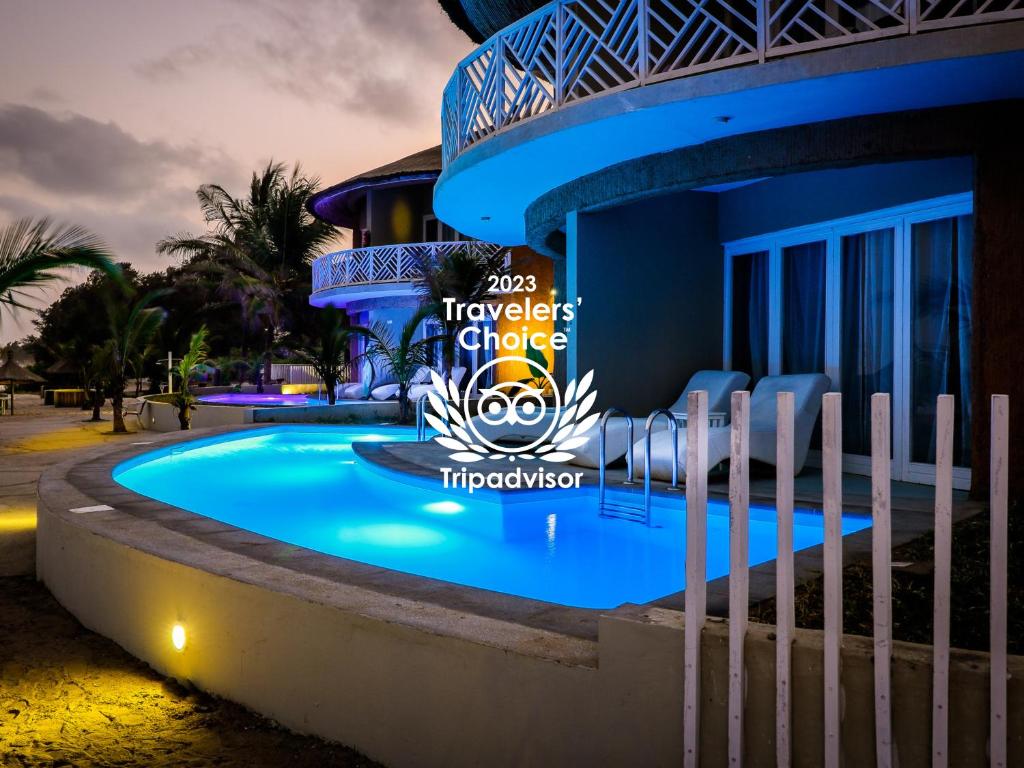 a view of the pool at the resort at night at Balafon Beach Resort in Kololi