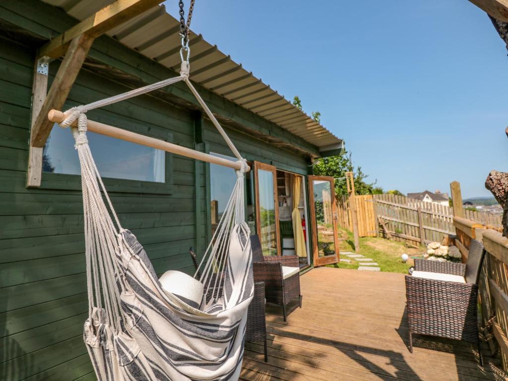 a hammock hanging from the side of a house at Dart View Hideout in Totnes